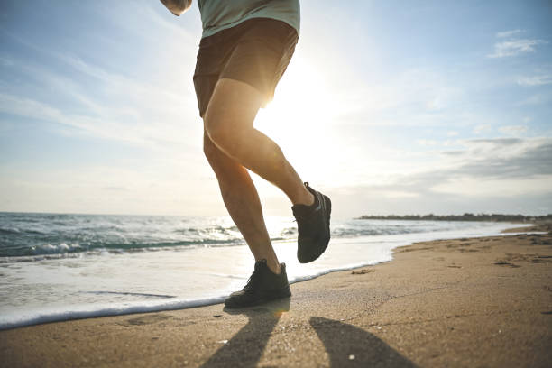 istock man walking and doing sports on the beach 1481847393