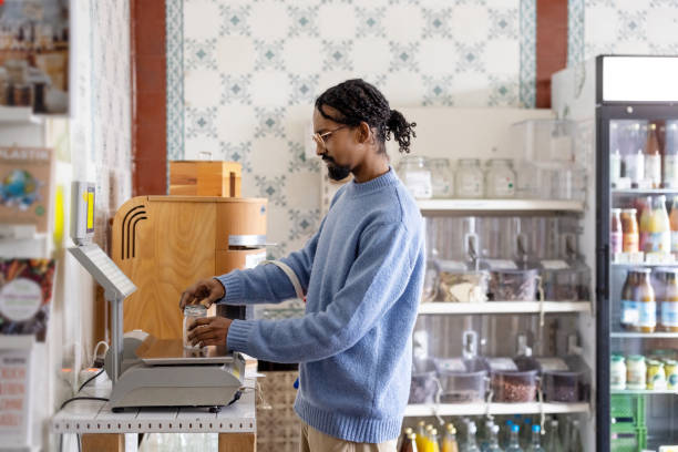 istock African man weighing a jar at package zero waste grocery store 1481847448