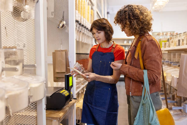 istock Store assistant helping a woman customer at zero waste shop 1481847451