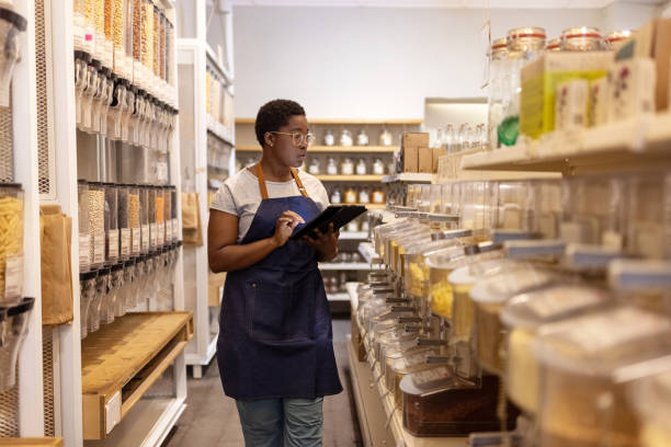 istock Store assistant checking inventory in a sustainable plastic-free store 1481847477