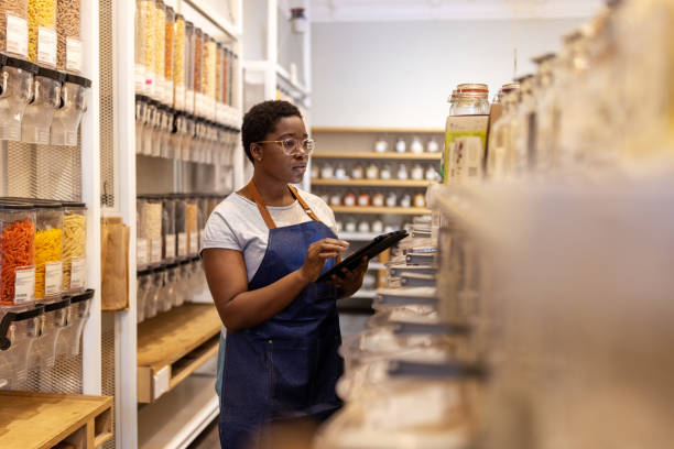 istock Store assistant checking stock in the eco-friendly grocery shop 1481847497