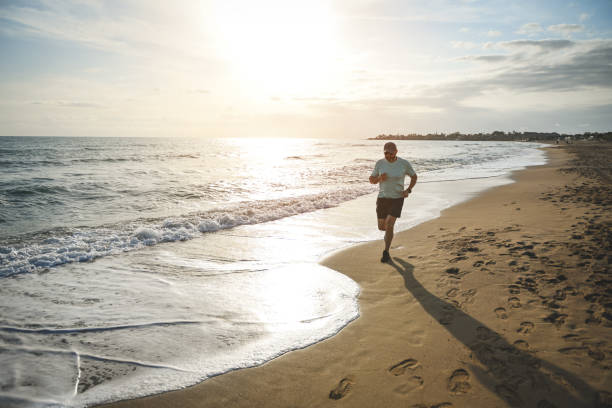 istock man walking and doing sports on the beach 1481847950