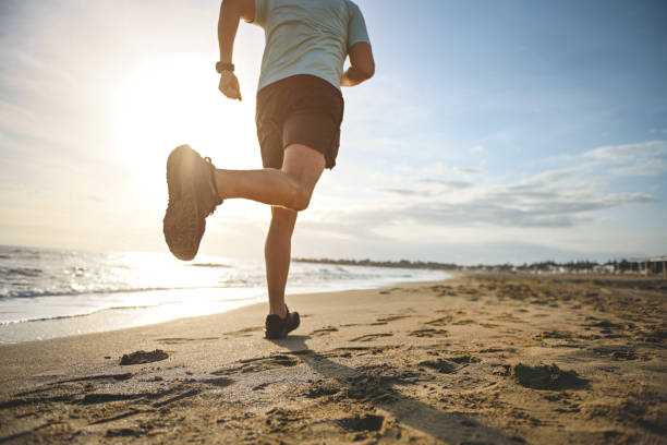 istock man walking and doing sports on the beach 1481849240