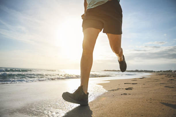 istock man walking and doing sports on the beach 1481849609