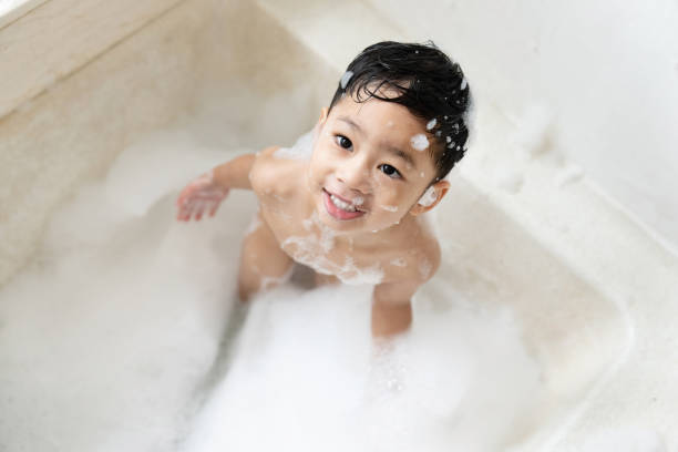 istock boy taking a bath in the tub take bath he plays with bubbles 1481849739