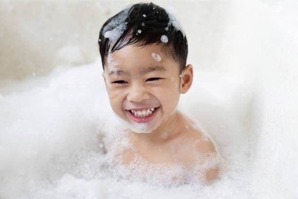istock boy taking a bath in the tub take bath he plays with bubbles 1481849767