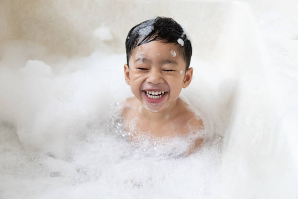 istock boy taking a bath in the tub take bath he plays with bubbles 1481850084