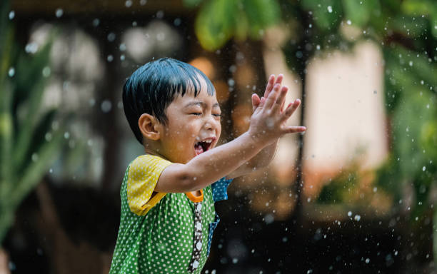 istock Asian children playing in the rain 1481850722