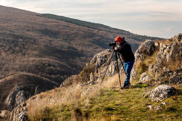 istock Photographer taking photos in mountains 1481851023