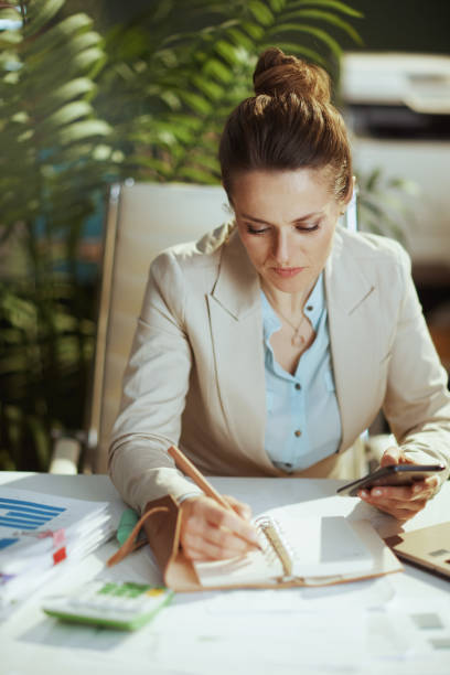 istock business woman in green office using smartphone applications 1481851433