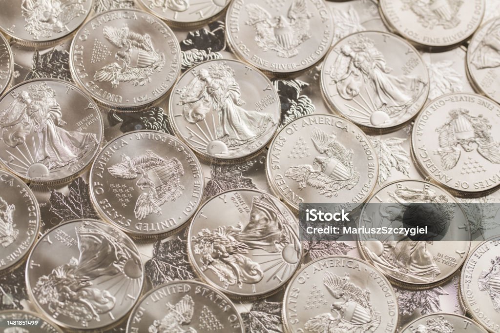 silver bullion coins silver and gold bullion on the table Coin Stock Photo