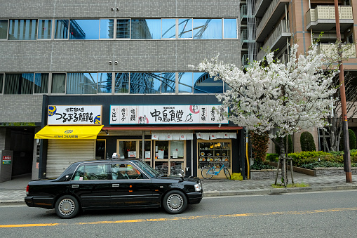 Osaka, Japan - March 24, 2023: A taxi in the Kita district of Osaka, Japan.
