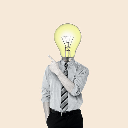 Creative Art collage of a man with a light bulb instead of a head pointing direction. Concept of business, ideas, professionalism and success. Modern design. Copy space.