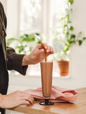 Woman drinking chocolate smoothie
Healthy smootie with hemp, chocolate poweder and vegetable milk