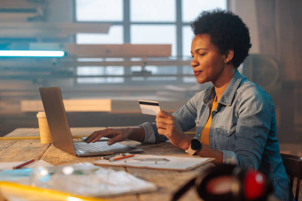 istock Female entrepreneur purchasing material online in workshop. 1481858211