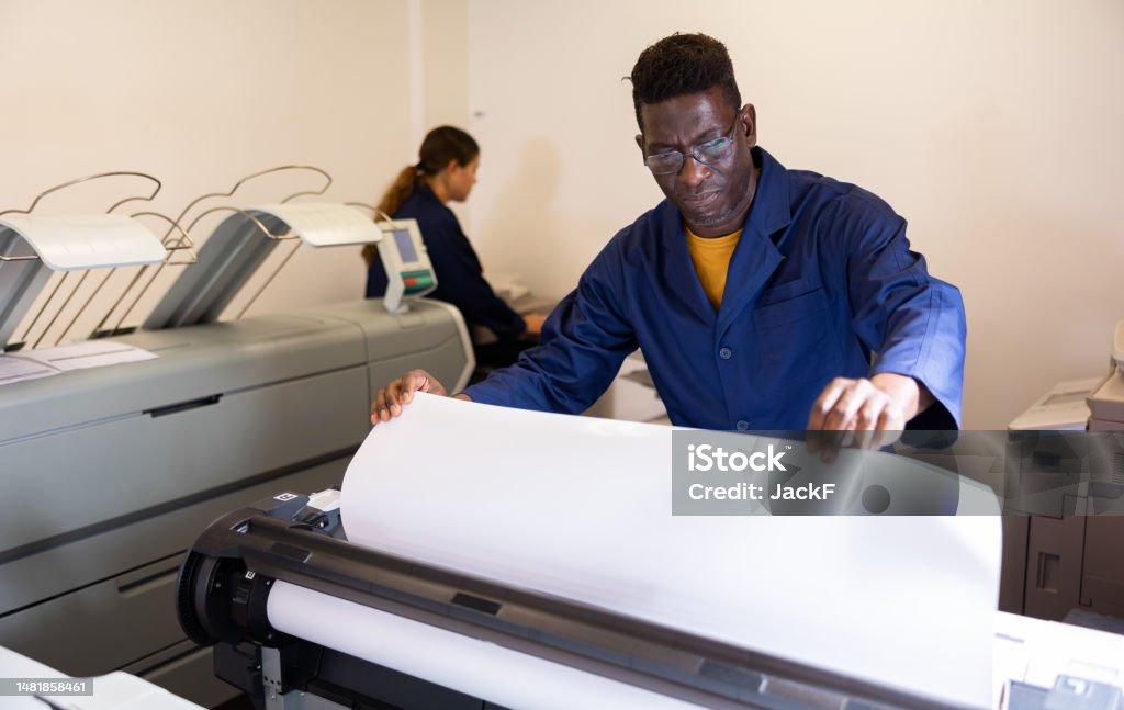 Man Using Plotter Serious Middleaged African American Man In Uniform Loading Large Format ...