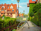 empty trolley shopping cart outside near apartment house entrance