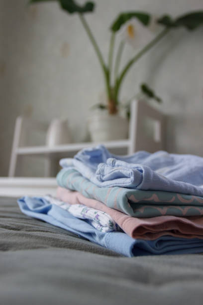 istock Clean colored clothes on the bed in a bedroom, blurred background 1481859320