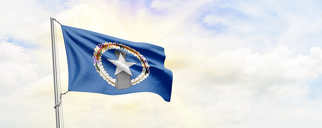 Northern Mariana Islands flag waving on sky background. 3D Rendering