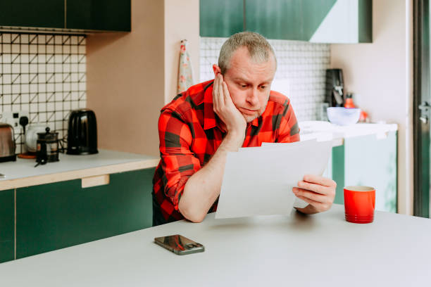 istock Worried man checking bills at home 1481862428