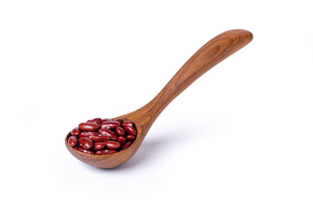 red beans or kidney bean in wooden spoon isolated on white - adzuki bean imagens e fotografias de stock