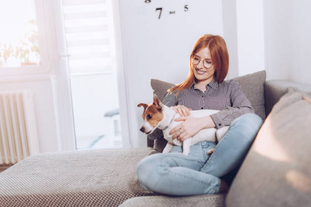 Natural ginger in her living room with her small dog