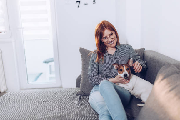 istock Natural ginger in her living room with her small dog 1481866010