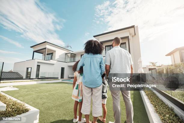 Love New House And Family In Their Backyard Together Looking At Their Property Or Luxury Real Estate Embrace Mortgage And Parents With Their Children On Grass At Their Home Or Mansion In Canada Stock Photo - Download Image Now