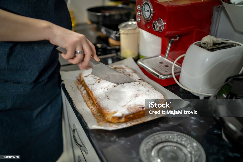 Woman cutting tasty cherry pie Adult Stock Photo