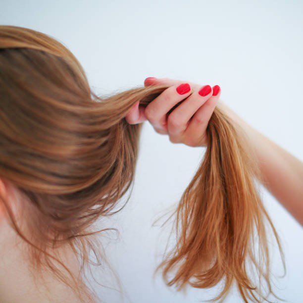 istock woman hand with red manicure keep hair 1481872433