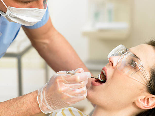 istock Dentist mirror in patients mouth 148187396