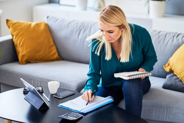 istock Woman at home working with financial documents 1481874059