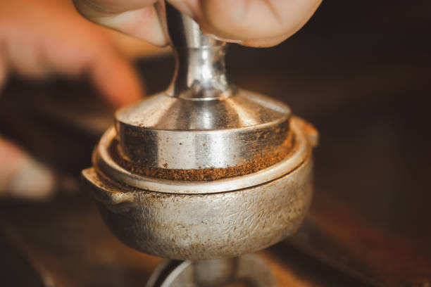 istock Tamped espresso finely ground coffee from a coffee grinder grinds freshly roasted coffee beans with a tamper. 1481875021