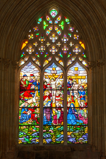 crucifiction of jesus in a stained glass cathedral window