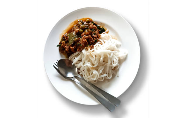 istock Stir-fried minced chicken with curry paste with eggplant and white thin noodles on a white plate 1481876347