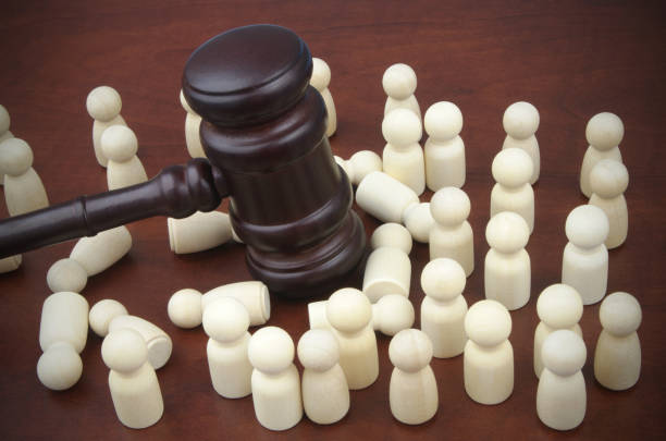 istock Judge gavel and many people figures, some figures laying on table. 1481876481