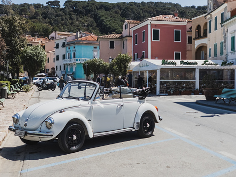 Marciana Marina, Italy - April 10, 2023: a classic VolksWagen car is parked at the seafront of Marciana Marina, a small tourist attraction in the Island of Elba in Tuscany.