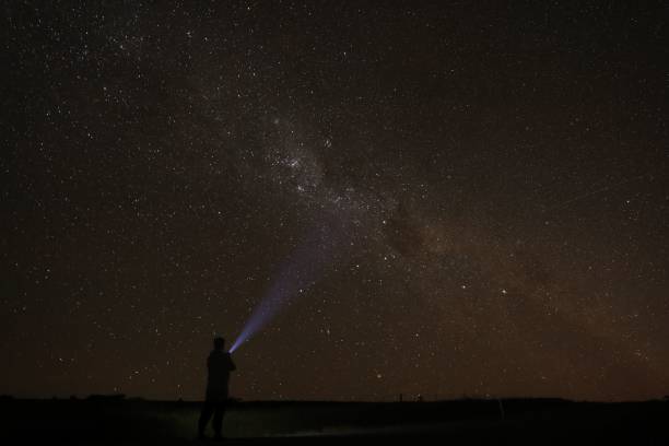 istock a man standing under a starry sky holding a beam 1481877703