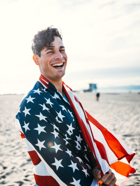 man with us national flag on the beach