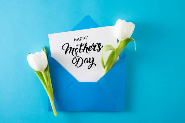 istock White Tulips with White Greeting Card in Blue Envelope 1481882307