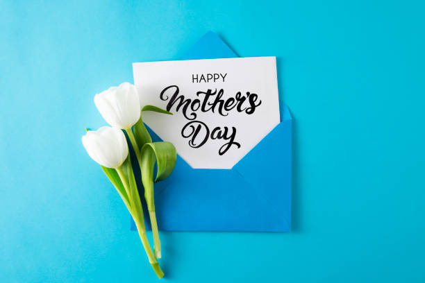istock White Tulips with White Greeting Card in Blue Envelope 1481883275