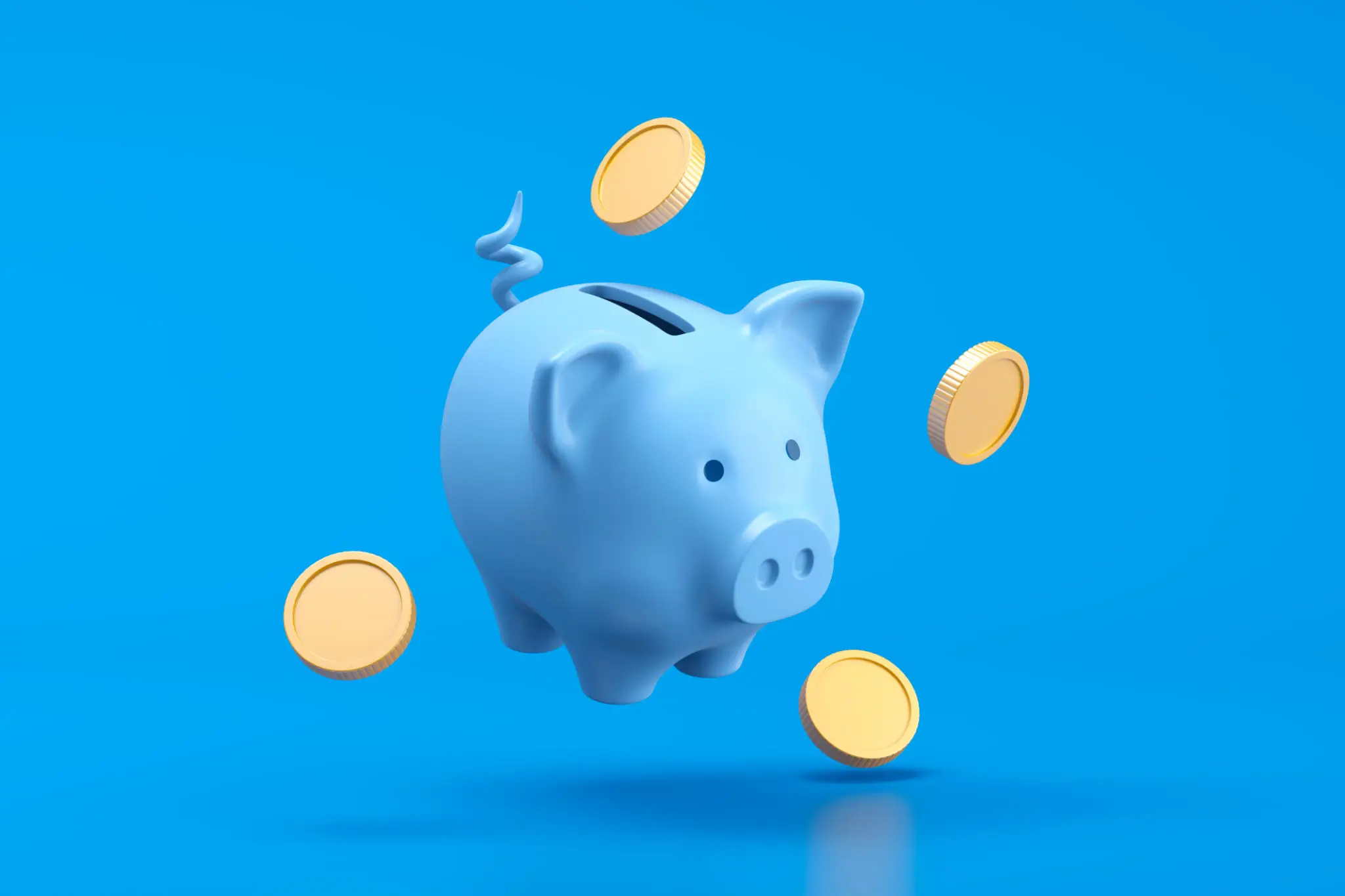 Piggy bank and money coin savings concept on blue background
