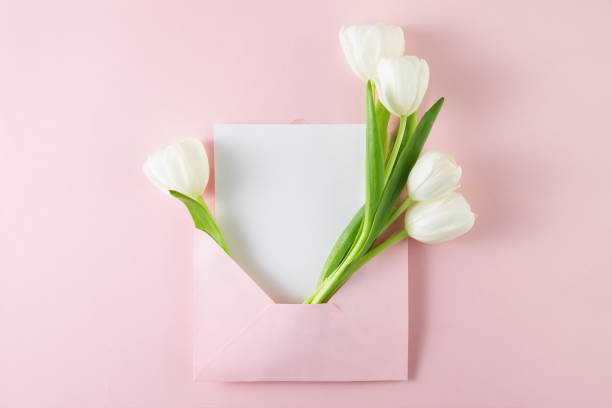 istock Tulips with White Greeting Card in Pink Envelope 1481884049