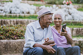 Portrait of a senior couple holding smartphone space for text