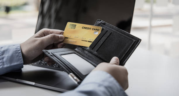 istock Young Asian man is taking a credit card 1481887525