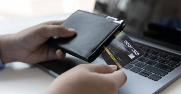 istock Young Asian man is taking a credit card 1481887534