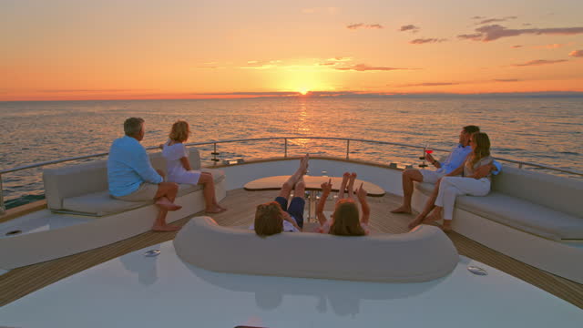 SLO MO TD Family enjoying chatting on the yacht at sunset