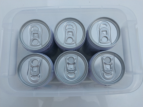 This photograph showcases six cans of delicious, ready-to-drink milk, packaged in a transparent plastic crate. The clear packaging allows for easy viewing of the milk cans and their labels, making it simple to identify your favorite flavors. Each can is perfectly sized for on-the-go convenience, whether you're heading to work, the gym, or simply need a quick and refreshing beverage. The cans are designed to preserve the freshness and flavor of the milk, ensuring a delicious and satisfying taste every time. With its simple and convenient packaging, this milk is the perfect choice for anyone who values quality, convenience, and taste. Whether you're a busy professional, a student, or simply someone who enjoys a delicious and refreshing beverage, these ready-to-drink milk cans are sure to satisfy.
