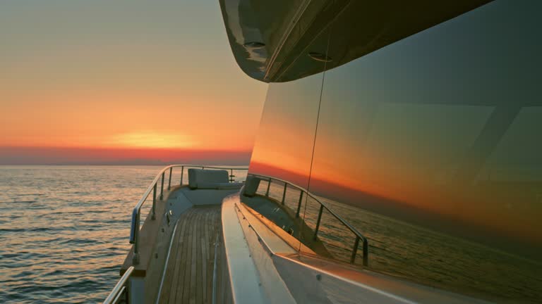 SLO MO Yacht travelling the sea at sunset