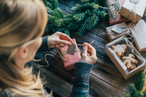 istock An unrecognizable woman is wrapping Christmas gifts. 1481908257